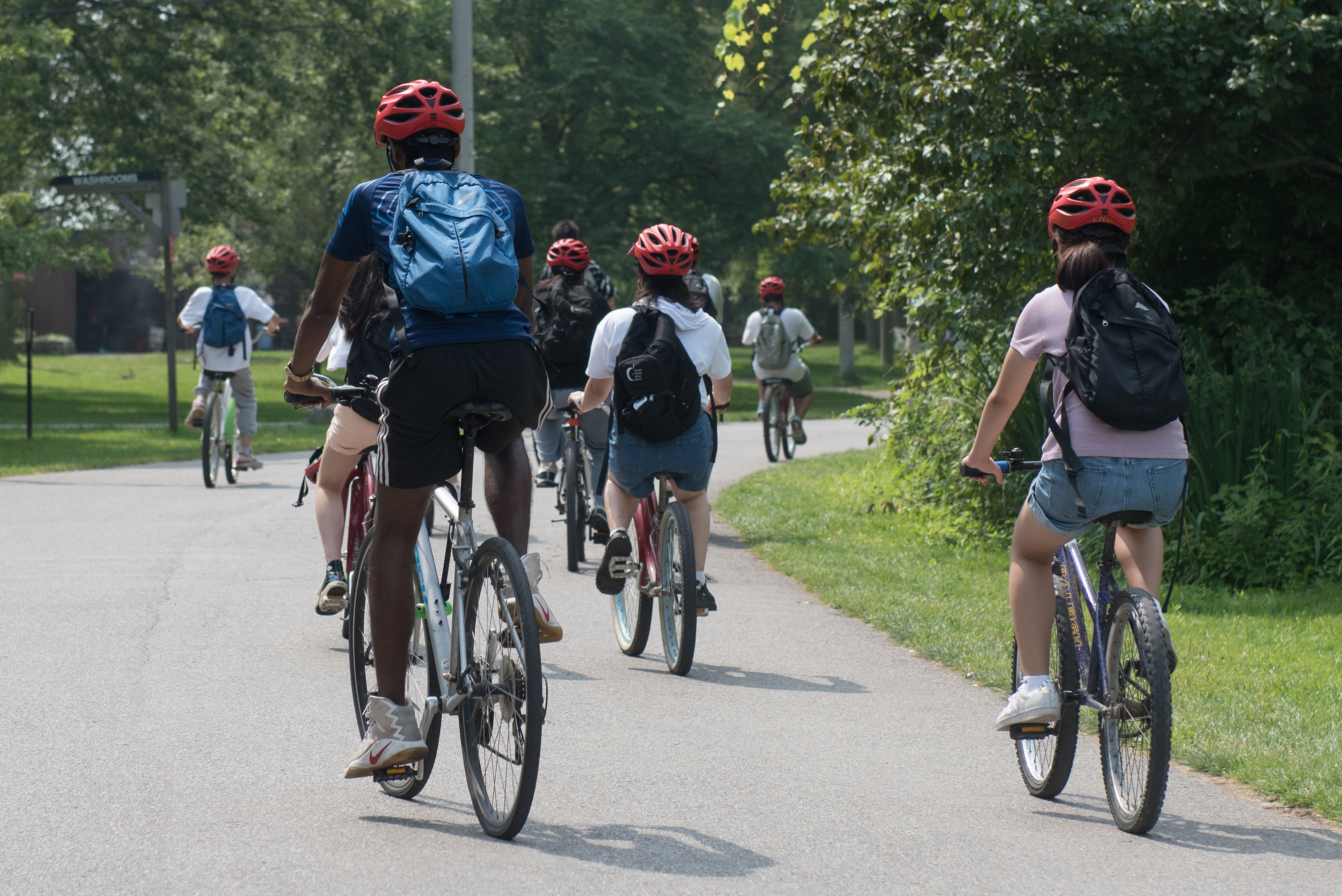 Students riding their bikes at Toronto Island Open Gallery